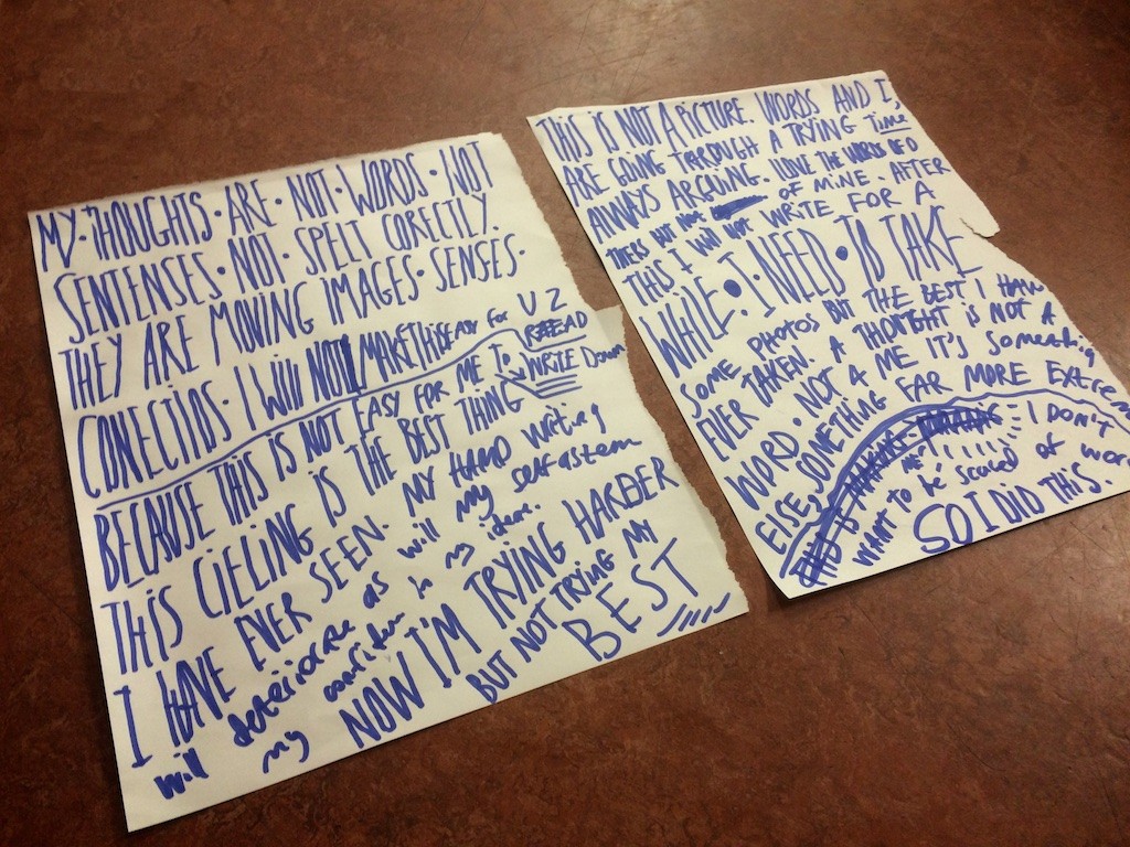 Two sheets of flipchart paper on which a poem has been written artistically