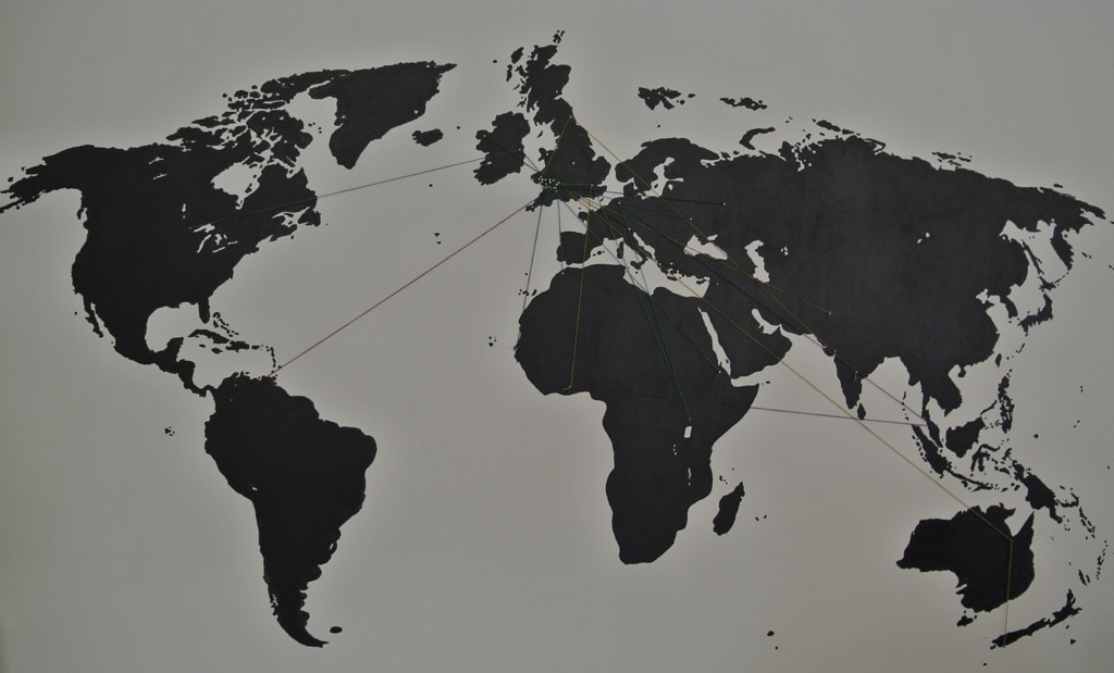 A map of the world with wool threads indicating where visitors have come from