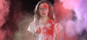 Girl amidst clouds of coloured powder