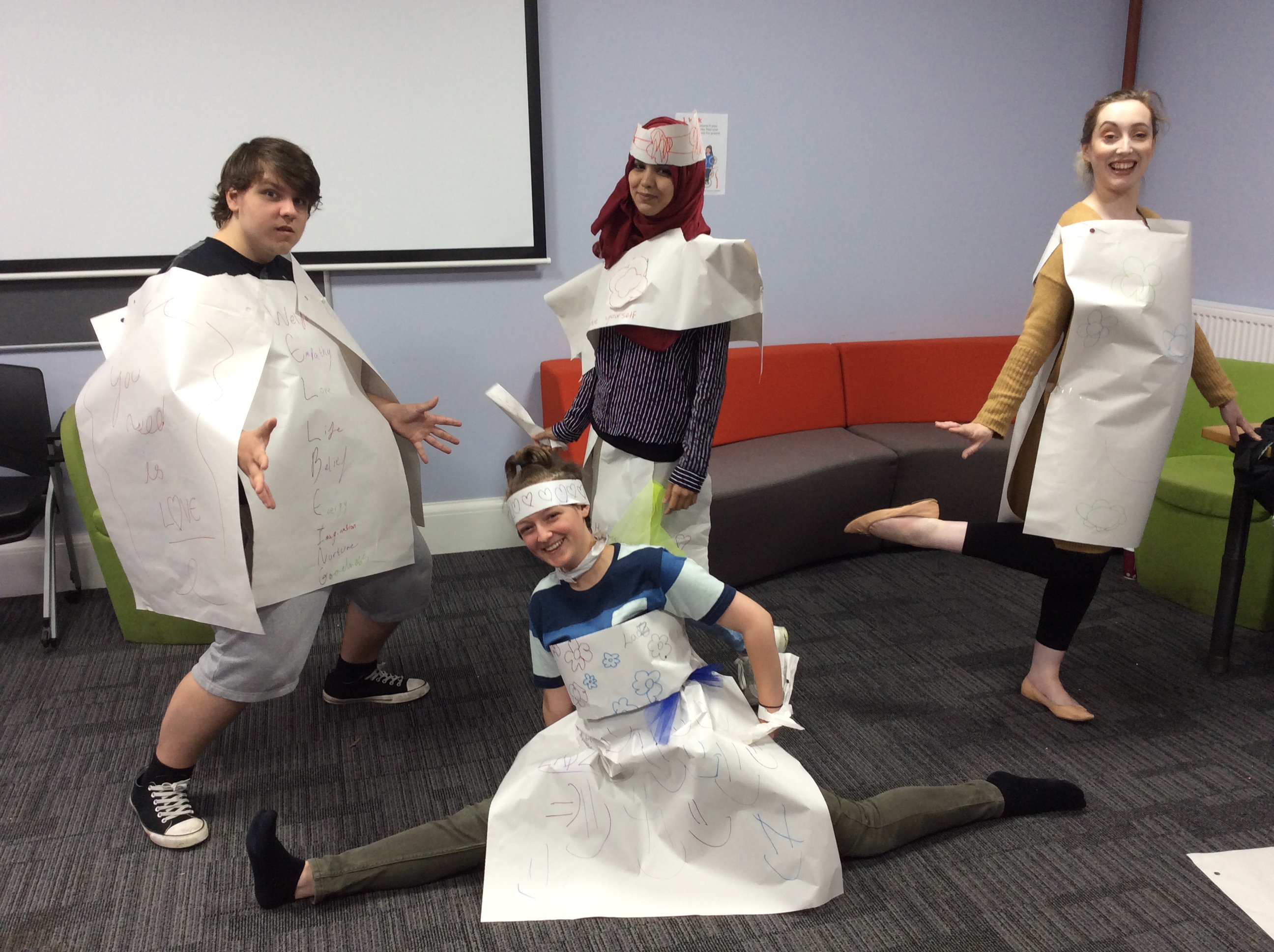 four people dressed in paper costumes